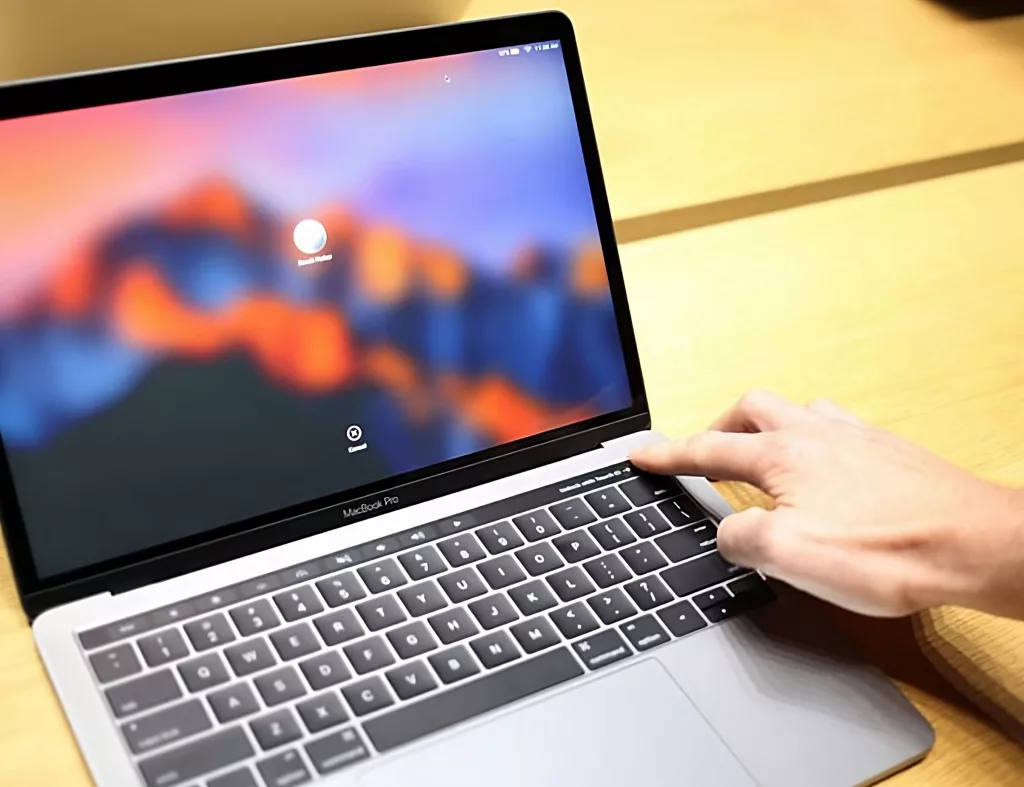 A person shutting down a MacBook